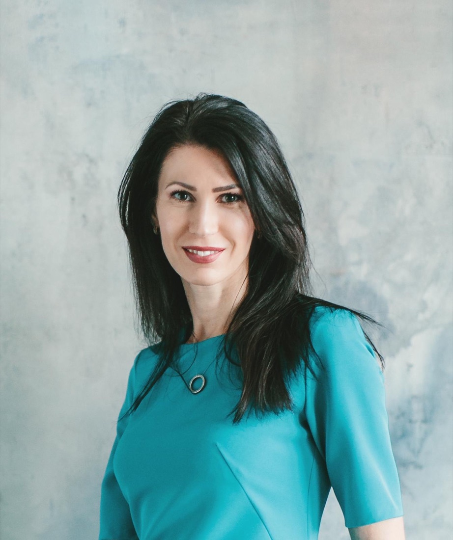 Studio portrait of Olga, professional astrologer, in a teal dress