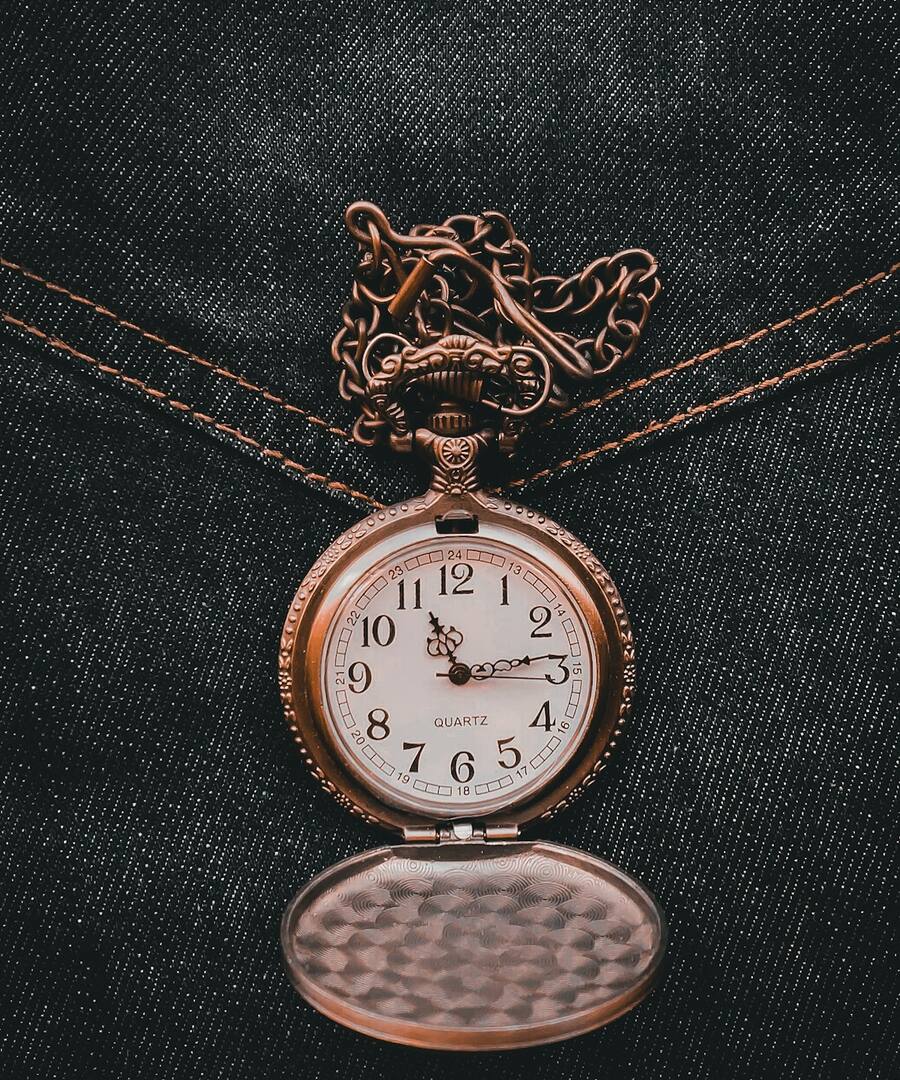 An antique clock face set against a starlit night sky